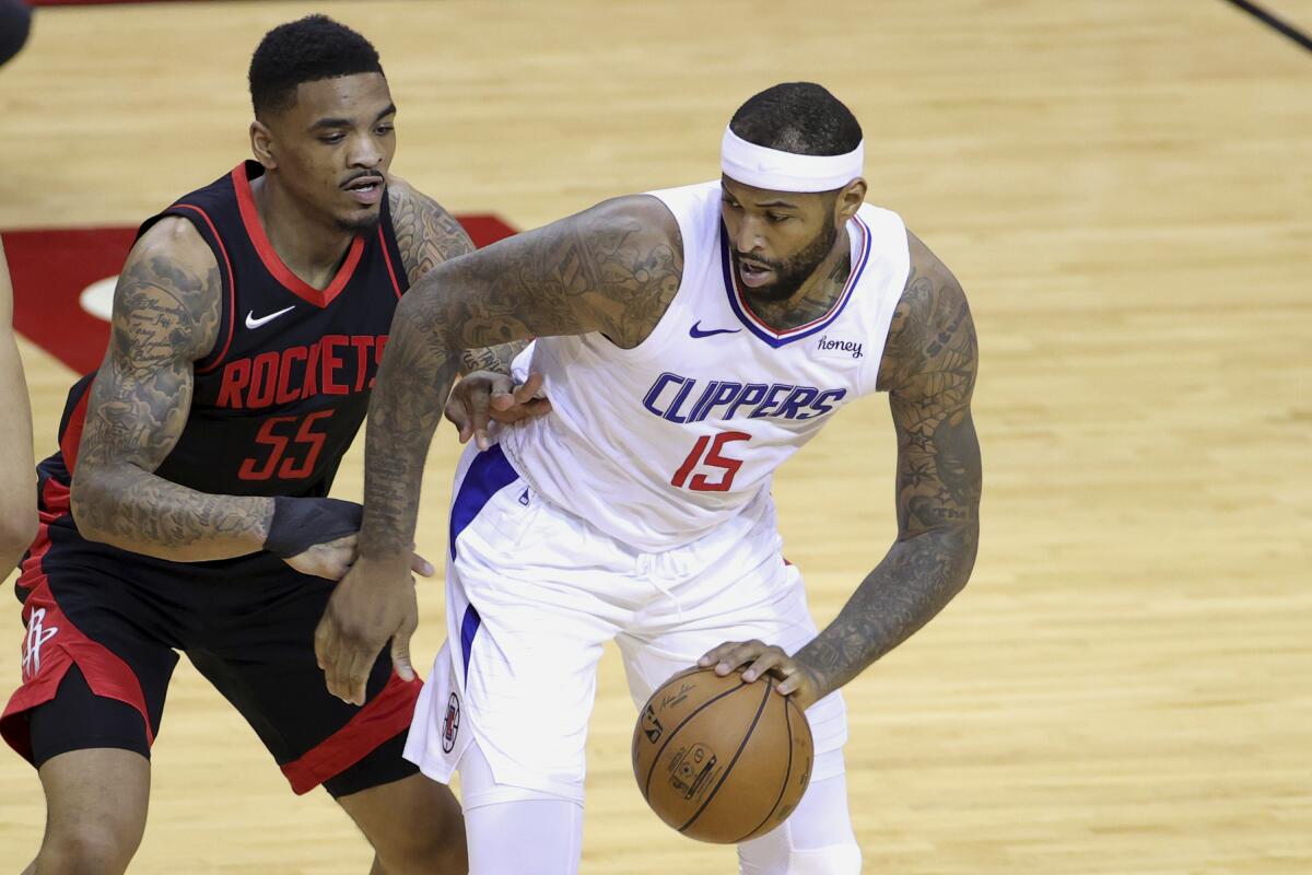 Clippers center DeMarcus Cousins works against Houston Rockets guard DaQuan Jeffries 