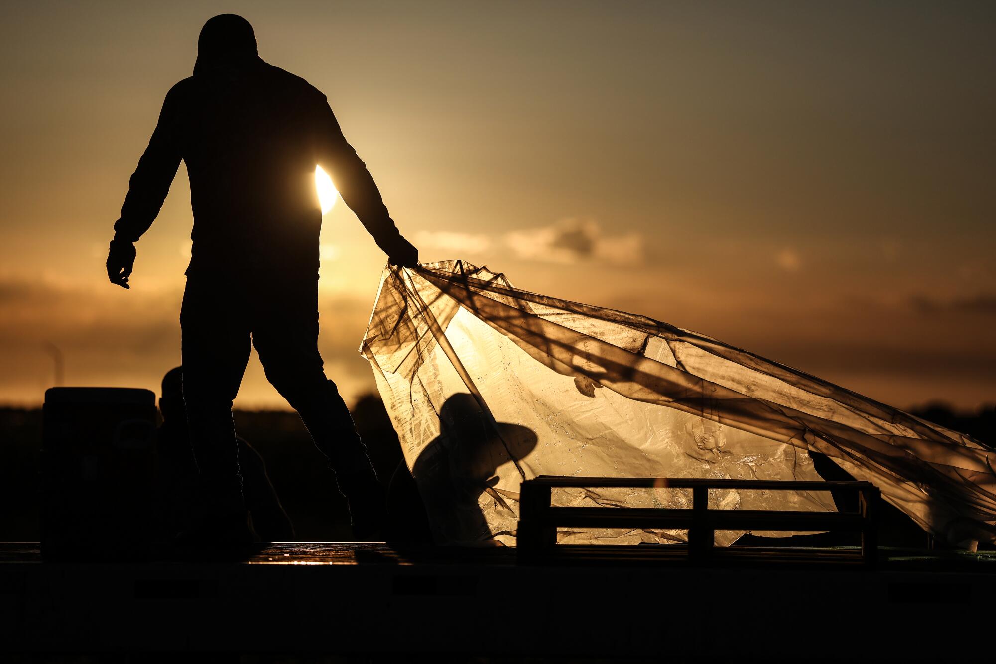 Farmworkers pack up for the day