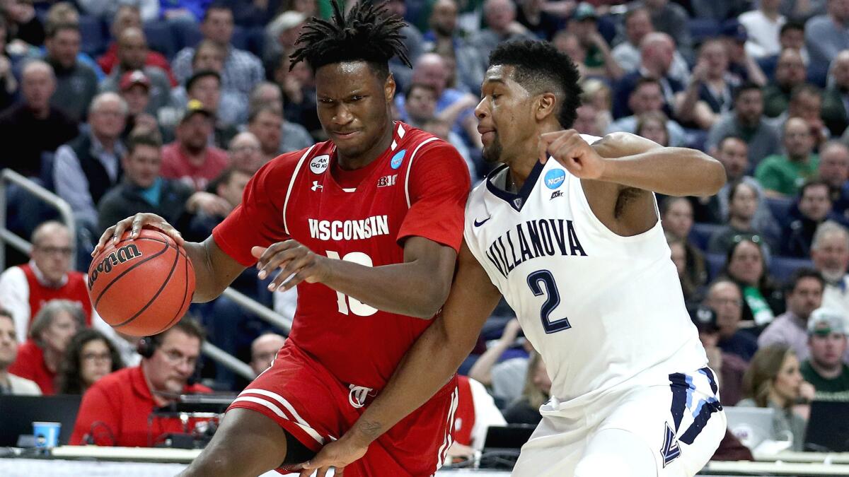 Wisconsin guard Nigel Hayes drives to the basket against Villanova guard Kris Jenkins during an East Regional game on Saturday.