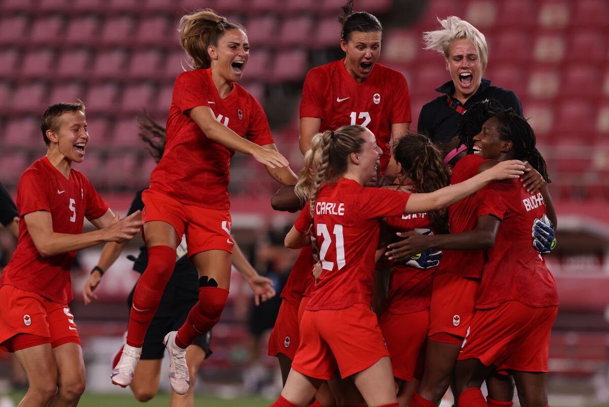 Canadian women's soccer players celebrate a victory at the Tokyo Olympics.