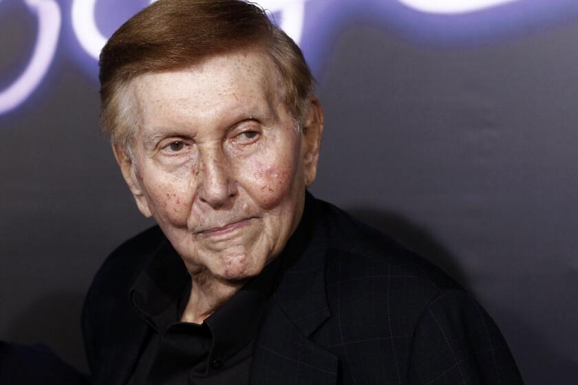 Sumner Redstone arrive at the premiere of "Footloose" in Los Angeles in 2011.