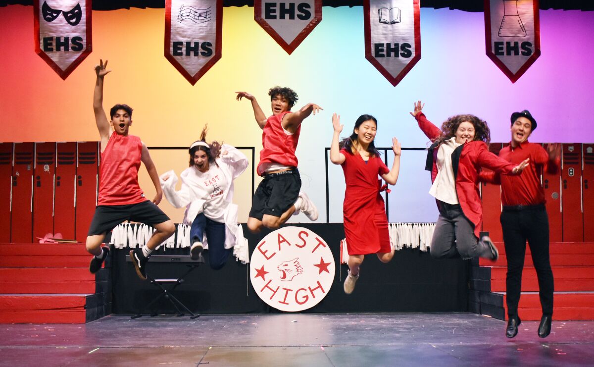 Lead actors in RB High's Disney’s “High School Musical” jumping in the air.