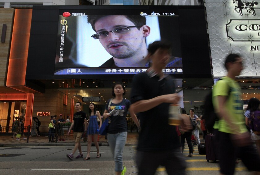 A TV screen at a Hong Kong shopping mall shows a news report on Edward Snowden.