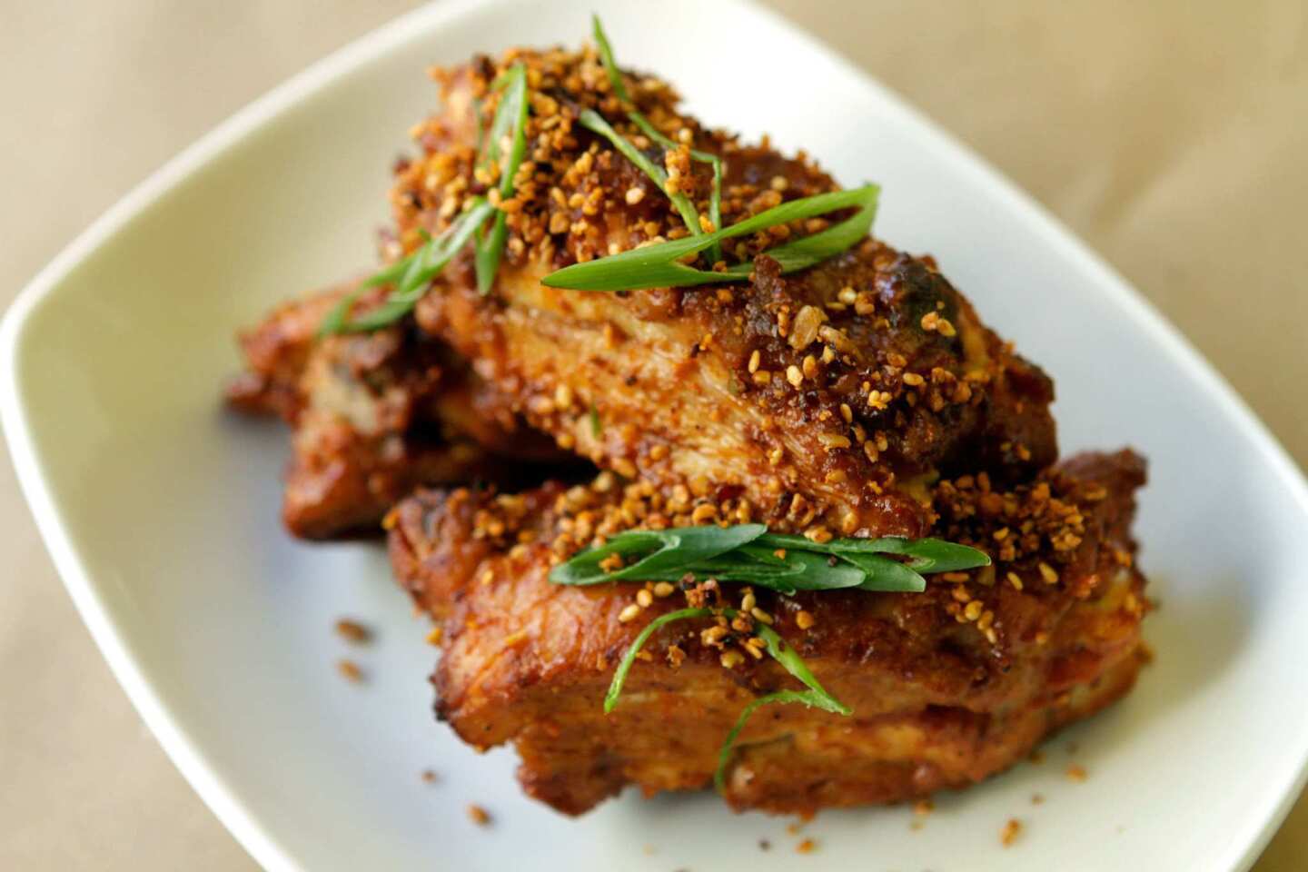 Szechuan- style chicken "ribs" with scallion, chile and sesame.