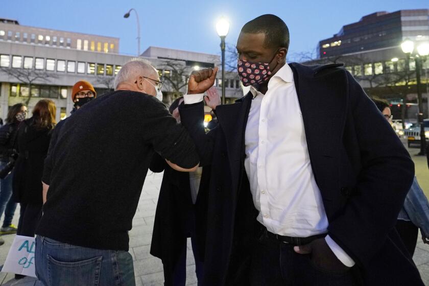 Rep.-elect Mondaire Jones, right, bumps elbows with a supporter after addressing a Protect the Results rally, Wednesday, Nov. 4, 2020, in front of the Westchester County Courthouse in White Plains, N.Y. Jones and Ritchie Torres, both Democrats, became the first gay Black men to be elected to Congress. (AP Photo/Kathy Willens)