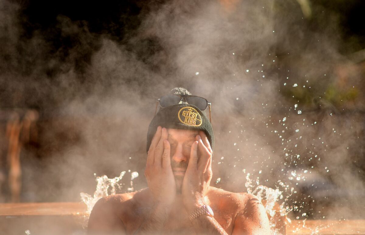 Boxer Tyson Fury sits in a jacuzzi following an early morning workout in Las Vegas.
