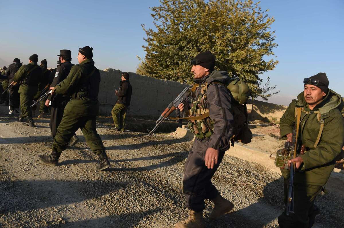 Afghan security officers arrive at the site of a suicide attack in Kabul on Nov. 18.