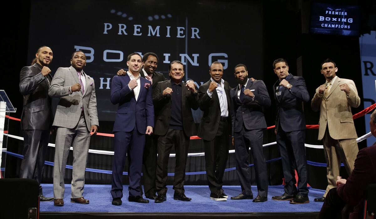 Boxing legends and current fighters, from left, Keith Thurman, Adrien Broner, Danny Garcia, Thomas Hearns, Roberto Duran, Sugar Ray Leonard, Lamont Peterson, John Molina Jr. and Robert Guerrero, pose for a picture during a news conference in New York on Jan. 14, 2015.