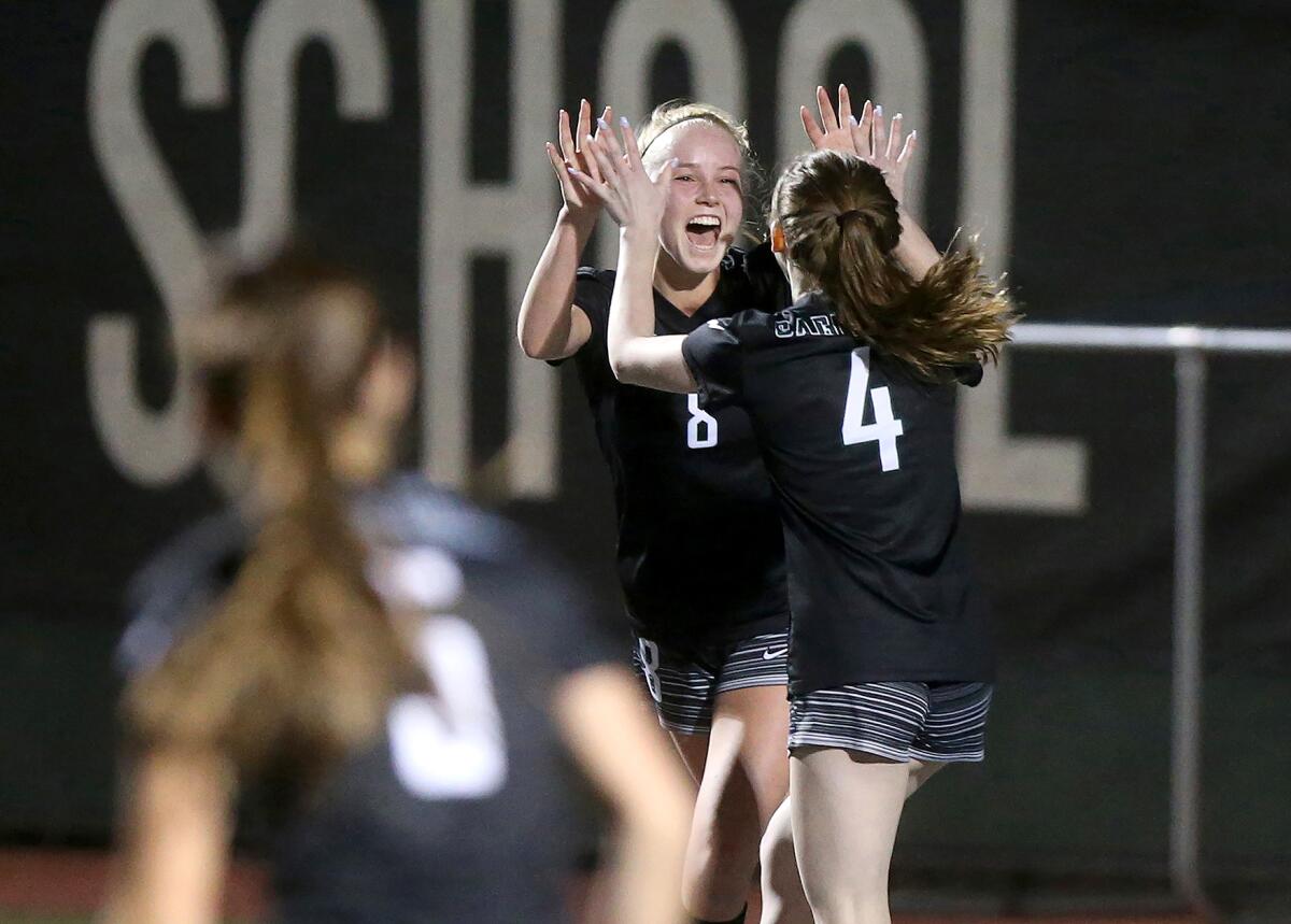 Sage Hill's Lauren Graham (8) celebrates with Jillian Raymer (4) after scoring a goal in the 39th minute of a San Joaquin League match against Pacifica Christian Orange County on Tuesday in Newport Beach.