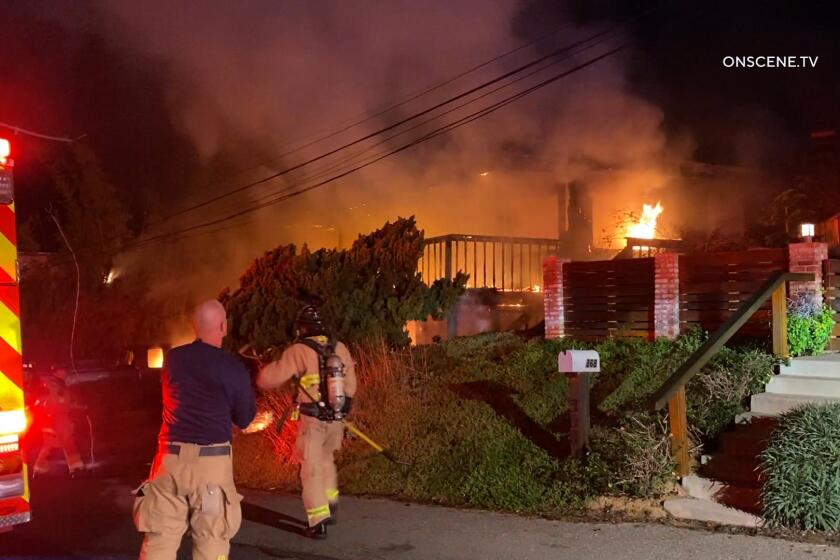 Flames heavily damaged two homes on Stafford Avenue in Encinitas Friday morning.