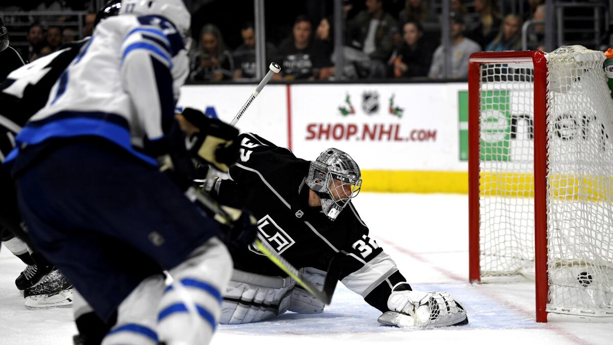 Jets center Adam Lowry watches his shot beat Kings goalie Jonathan Quick during the first period Wednesday.