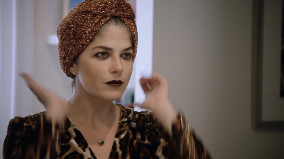 A close-up of Selma Blair in a turban and dark lipstick.