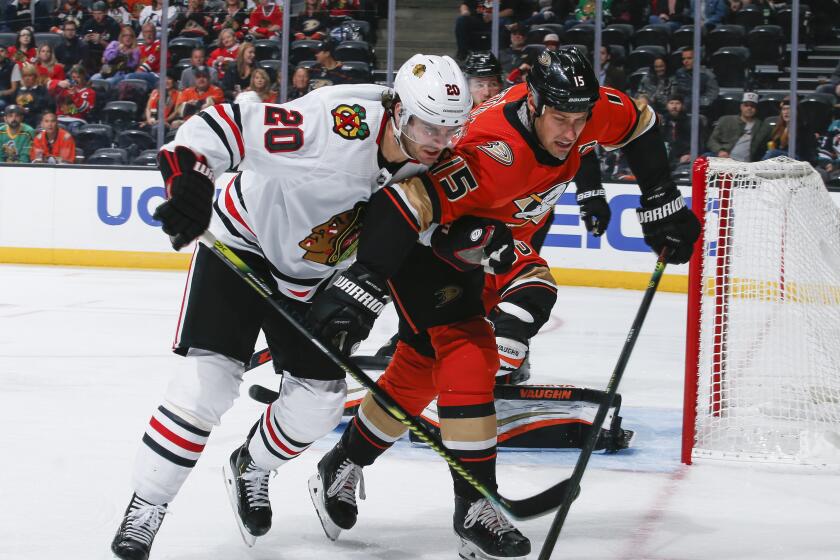 ANAHEIM, CA - NOVEMBER 3: Brandon Saad #20 of the Chicago Blackhawks and Ryan Getzlaf #15 of the Anaheim Ducks battle for the puck during the second period of the game at Honda Center on November 3, 2019 in Anaheim, California. It was Getzlafs 1,000th NHL career game, all of which were for the Ducks franchise. (Photo by Debora Robinson/NHLI via Getty Images)