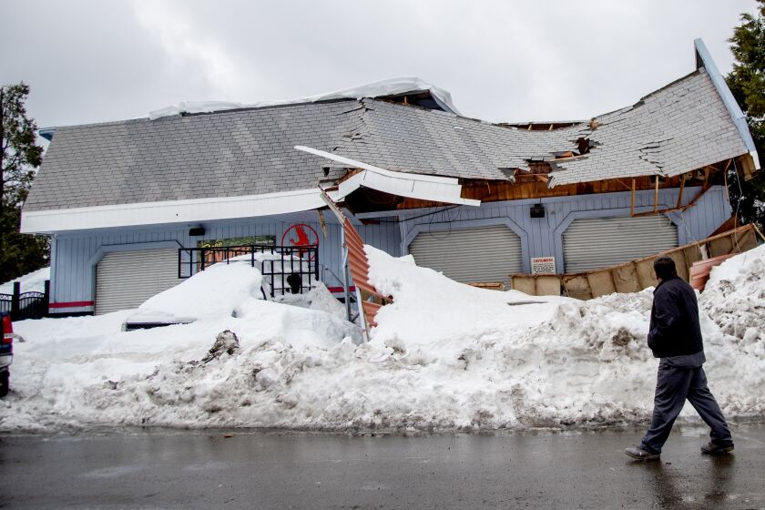 CRESTLINE, CA - MARCH 6, 2023: A roof has collapsed on a local business after recent storms dropped more than 100 inches of snow in the San Bernardino Mountains on March 6, 2023 in Crestline, California. (Gina Ferazzi / Los Angeles Times)