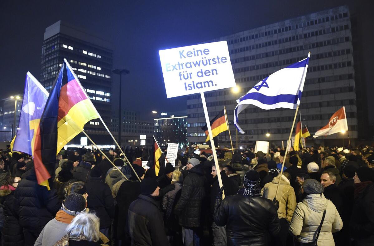 Anti-Islam protesters hold a poster reading "Stop Islamization of Europe" at a rally in Berlin on Monday.