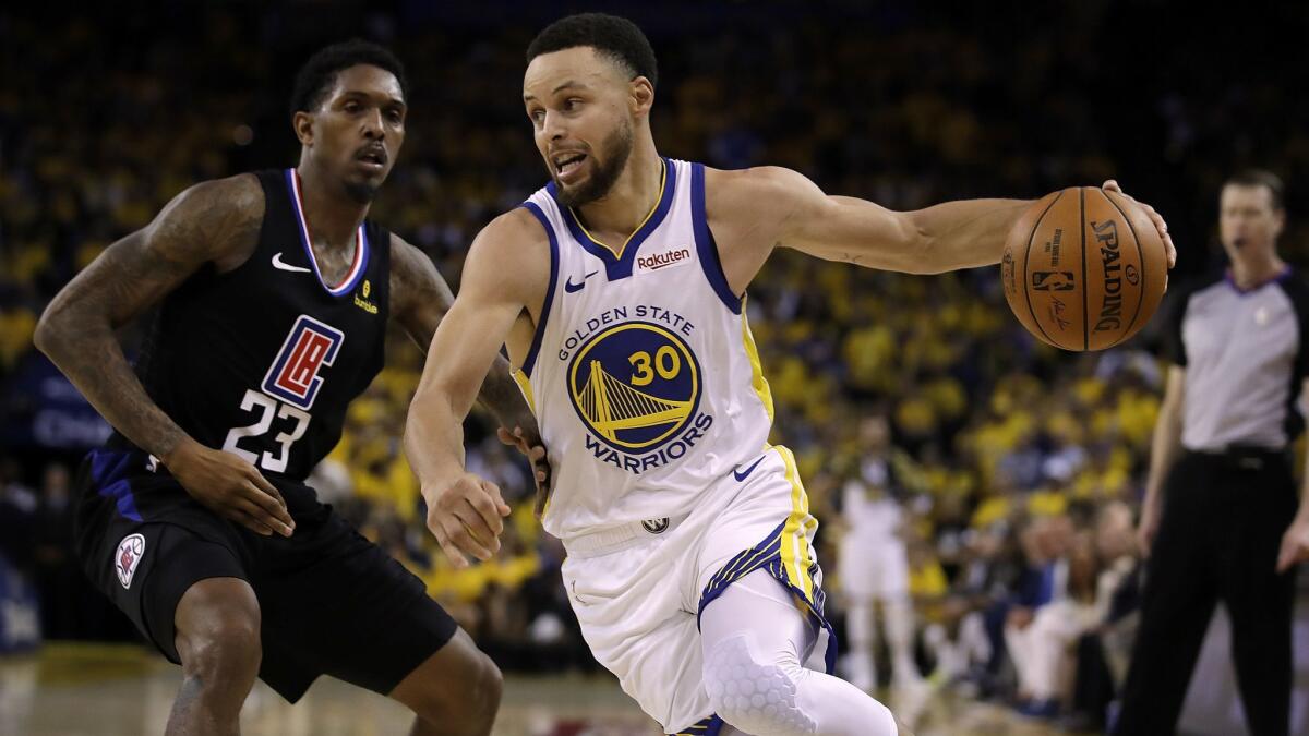 Golden State Warriors' Stephen Curry, right, drives the ball around Clippers' Lou Williams (23) during the second half in Game 1 of a first-round NBA playoff series on Saturday in Oakland.