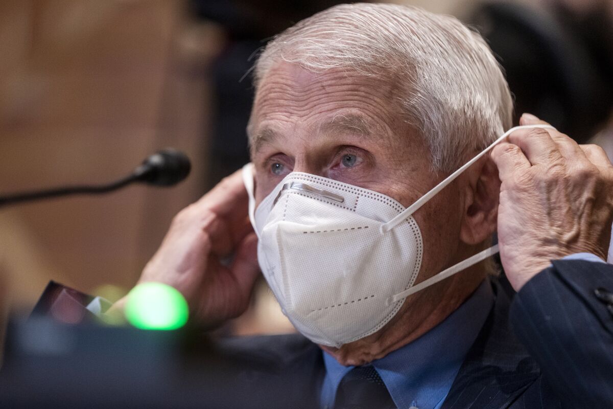 Dr. Anthony Fauci dons a mask during a Senate subcommittee hearing on Capitol Hill on May 17, 2022.