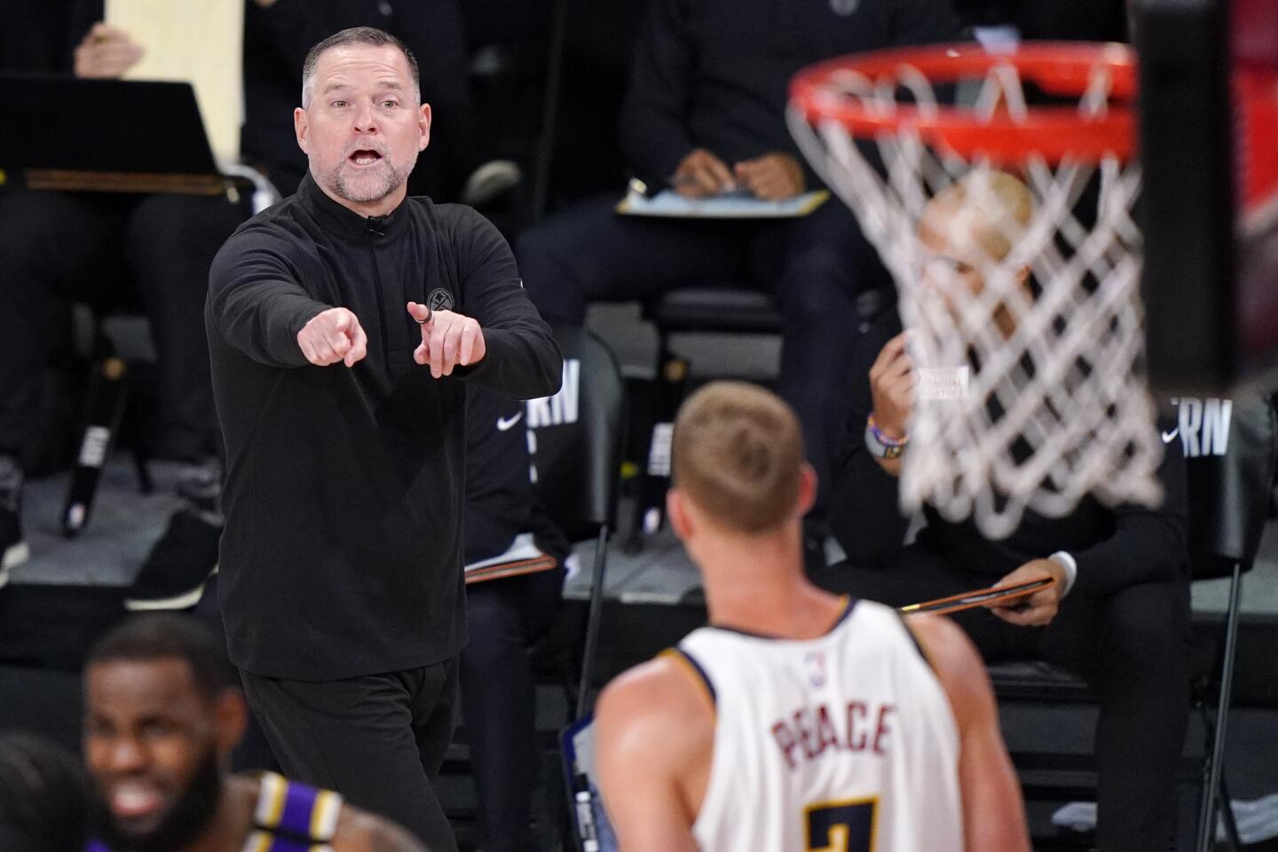 Denver coach Michael Malone talks to center Mason Plumlee during Game 5.