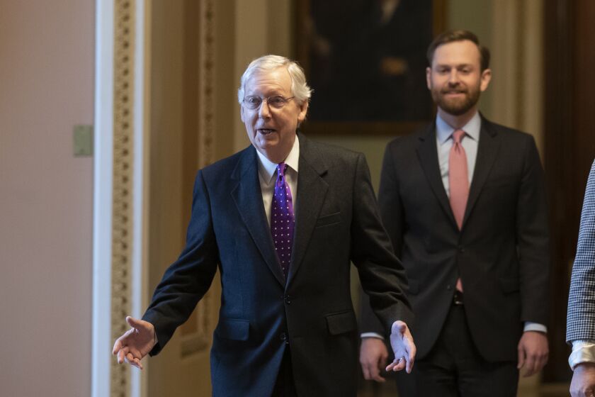 Senate Majority Leader Mitch McConnell of Ky., left, walks from the Senate Floor on Capitol Hill, Tuesday, Feb. 4, 2020 in Washington. (AP Photo/Alex Brandon)