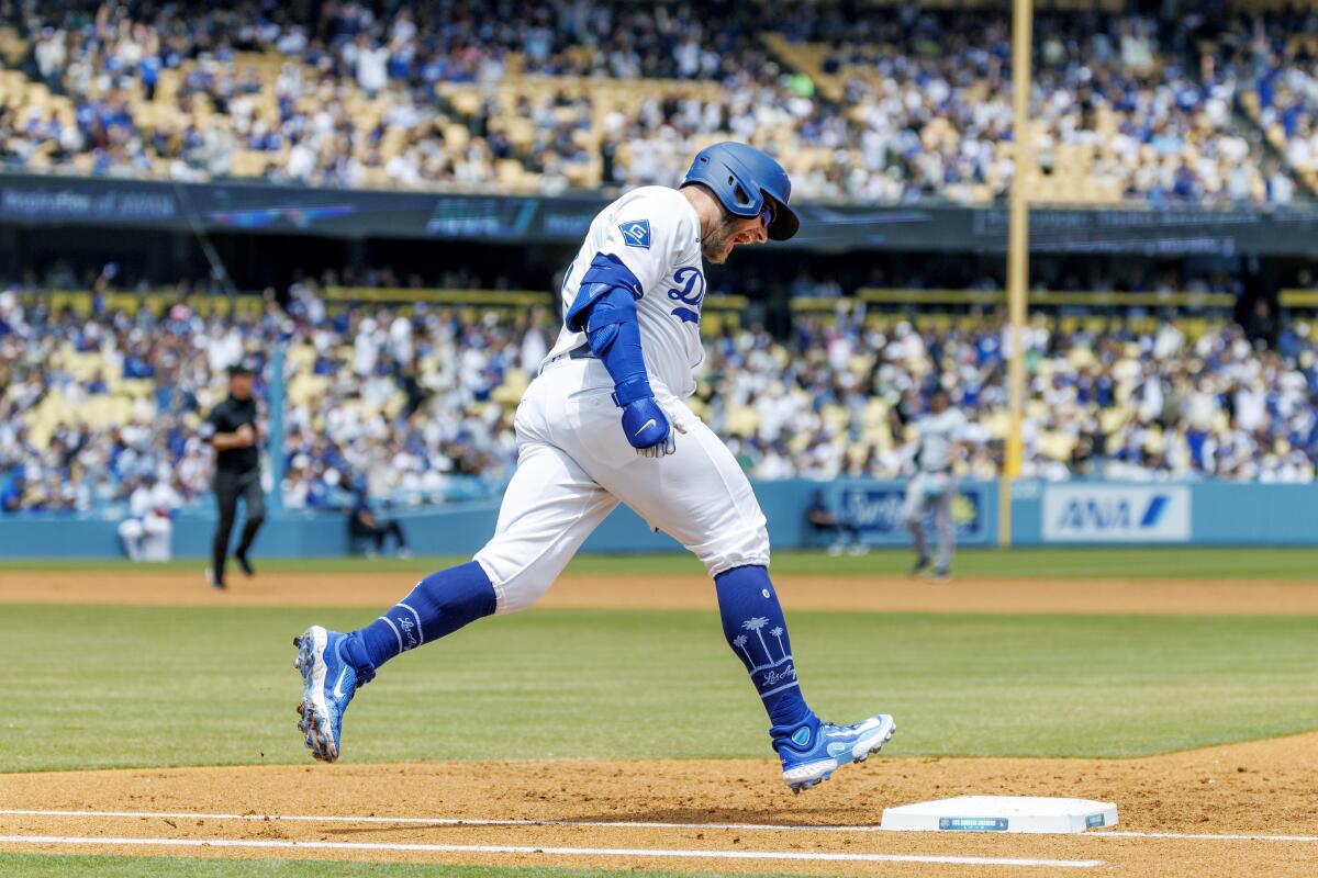 The Dodgers' Max Muncy reacts as he runs the bases after hitting a solo homer during Wednesday's game at Dodger Stadium.