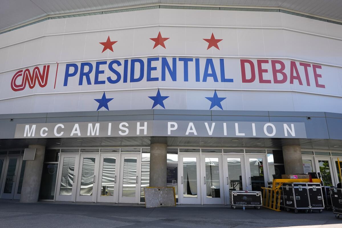 Signs outside a building read "CNN presidential debate" and "McCamish Pavilion" 