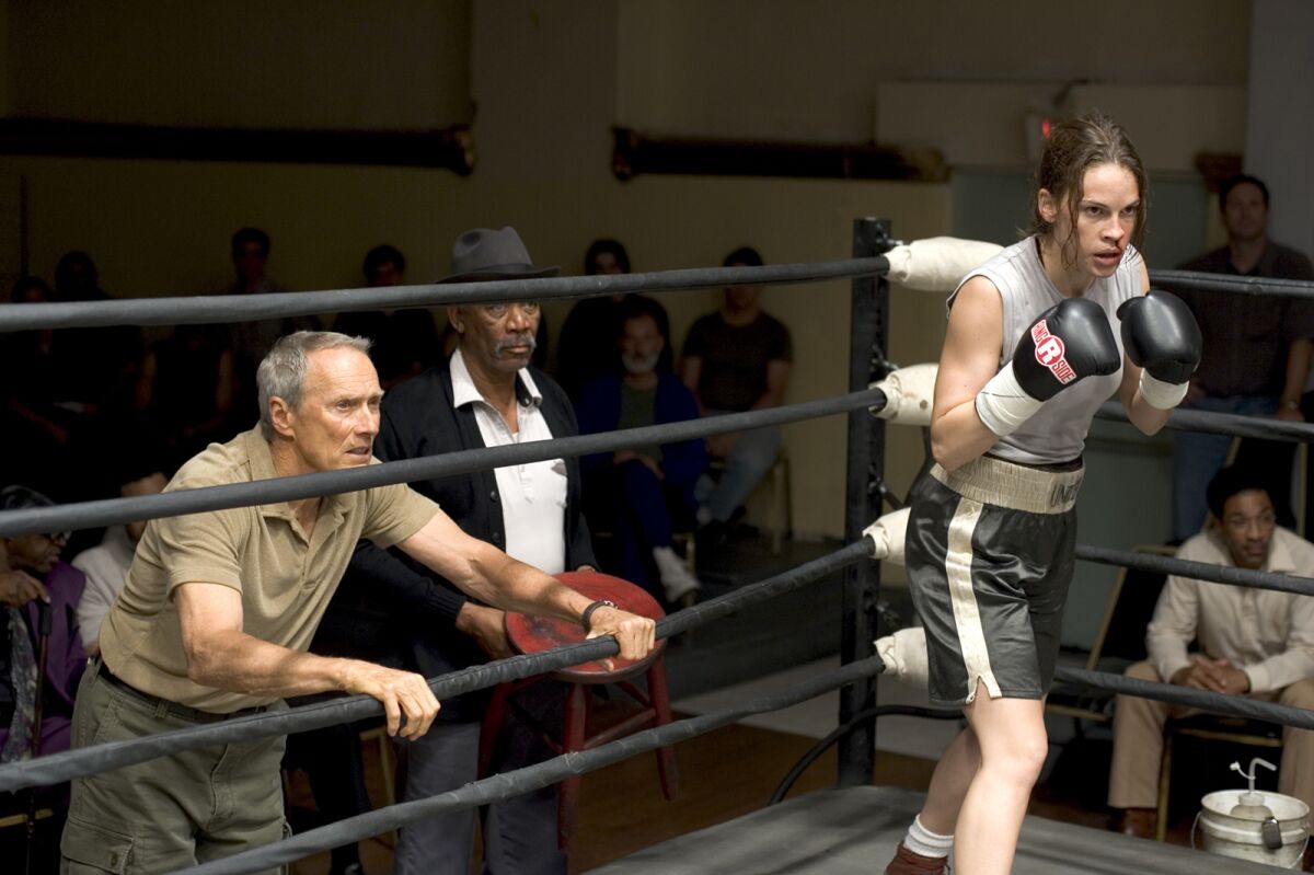 Hilary Swank holds up her arms in the boxing ring in a scene from “Million Dollar Baby."