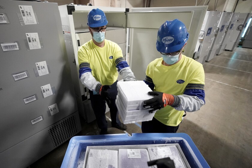 FILE - Boxes containing the Pfizer COVID-19 vaccine are prepared to be shipped at the Pfizer Global Supply Kalamazoo manufacturing plant in Portage, Mich., Dec. 13, 2020. The nation's COVID-19 death toll stands at around 800,000 as the anniversary of the U.S. vaccine rollout arrives. A year ago it stood at 300,000. What might have been a time to celebrate a scientific achievement is fraught with discord and mourning. (AP Photo/Morry Gash, Pool, File)