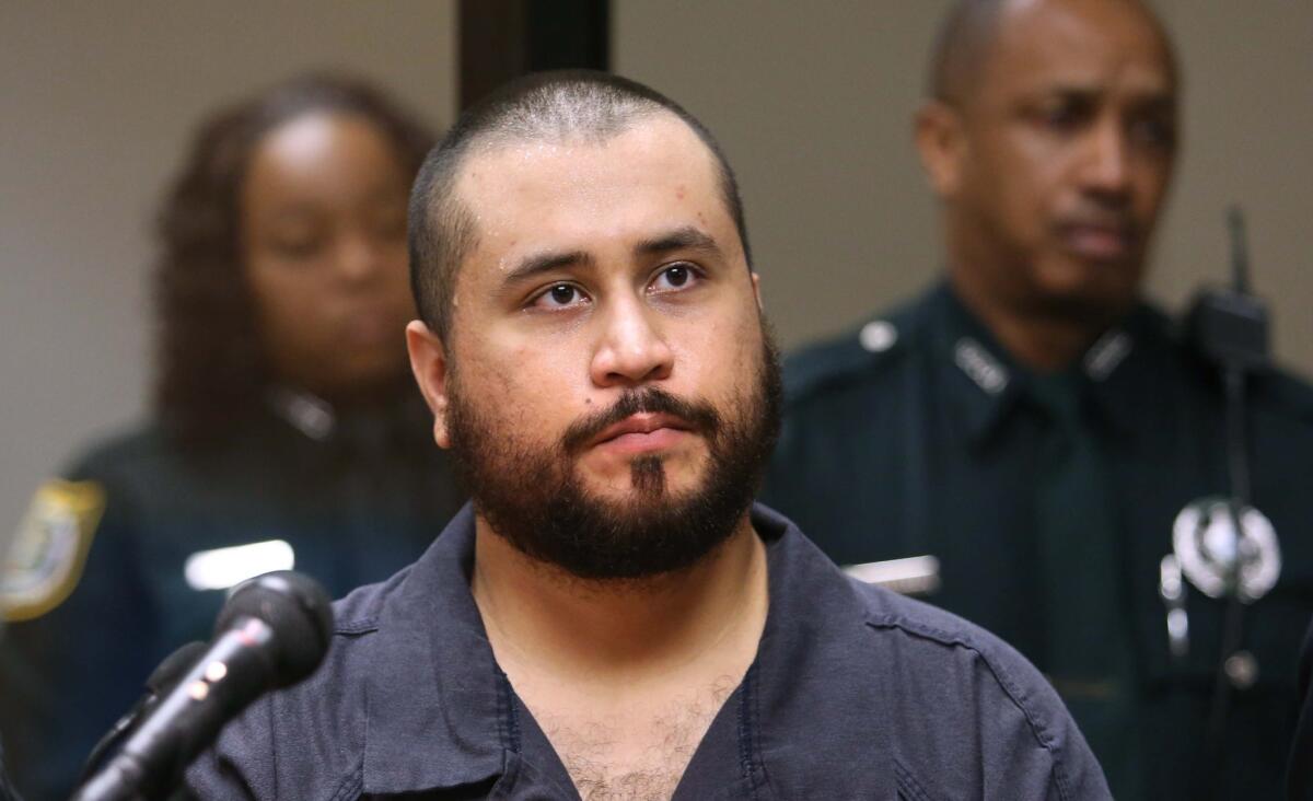 George Zimmerman, who was acquitted in the killing of Trayvon Martin, listens in court, in Sanford, Fla., during a November 2013 hearing.