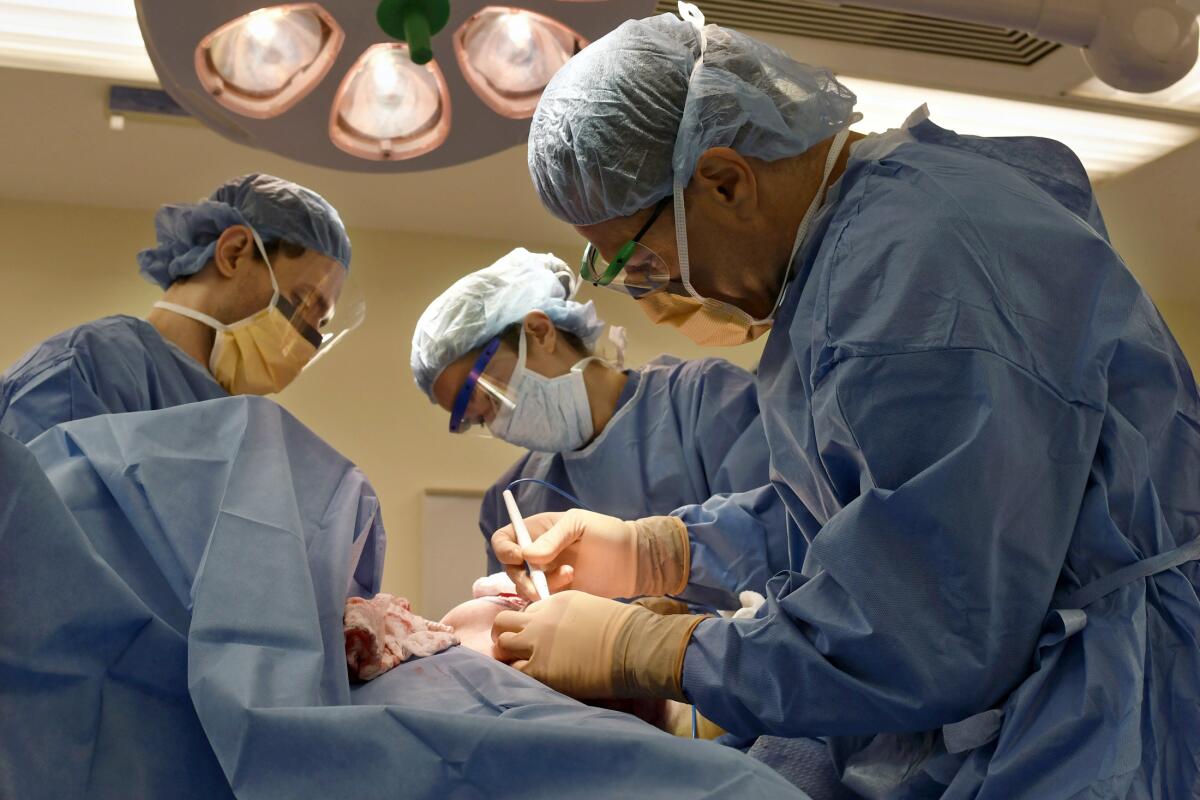 Surgeons perform a bilateral mastectomy on a transgender patient at a hospital in Boston. 