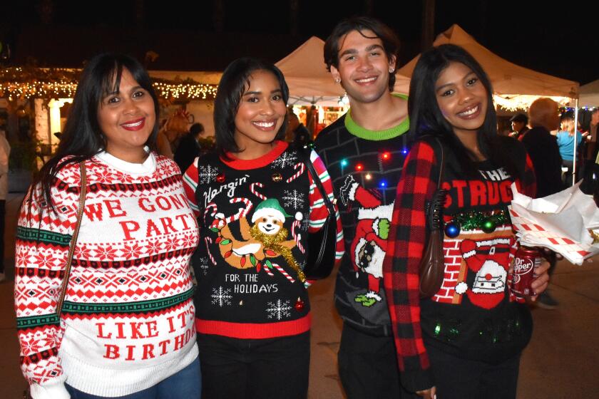 Wearing festive holiday sweaters were Hayley Watts, Monika Watts, Anthony Logan and Angelica Watts.