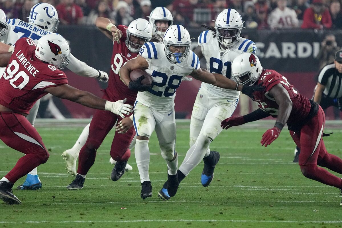 Indianapolis Colts running back Jonathan Taylor (28) runs against the Arizona Cardinals during the second half of an NFL football game, Saturday, Dec. 25, 2021, in Glendale, Ariz. (AP Photo/Rick Scuteri)