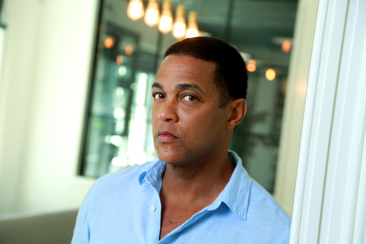 Don Lemon, in a blue collared shirt, is framed in a head-and-shoulders portrait, looking at camera.