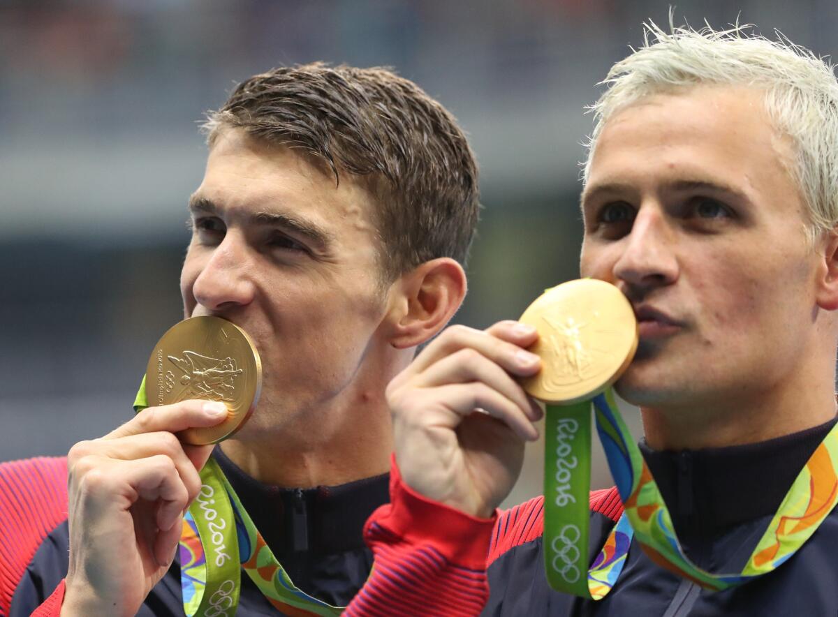 U.S. swimmers Michael Phelps, left, and Ryan Lochte celebrate winning Olympic gold medals in the men's 800-meter freestyle relay on Aug. 10.