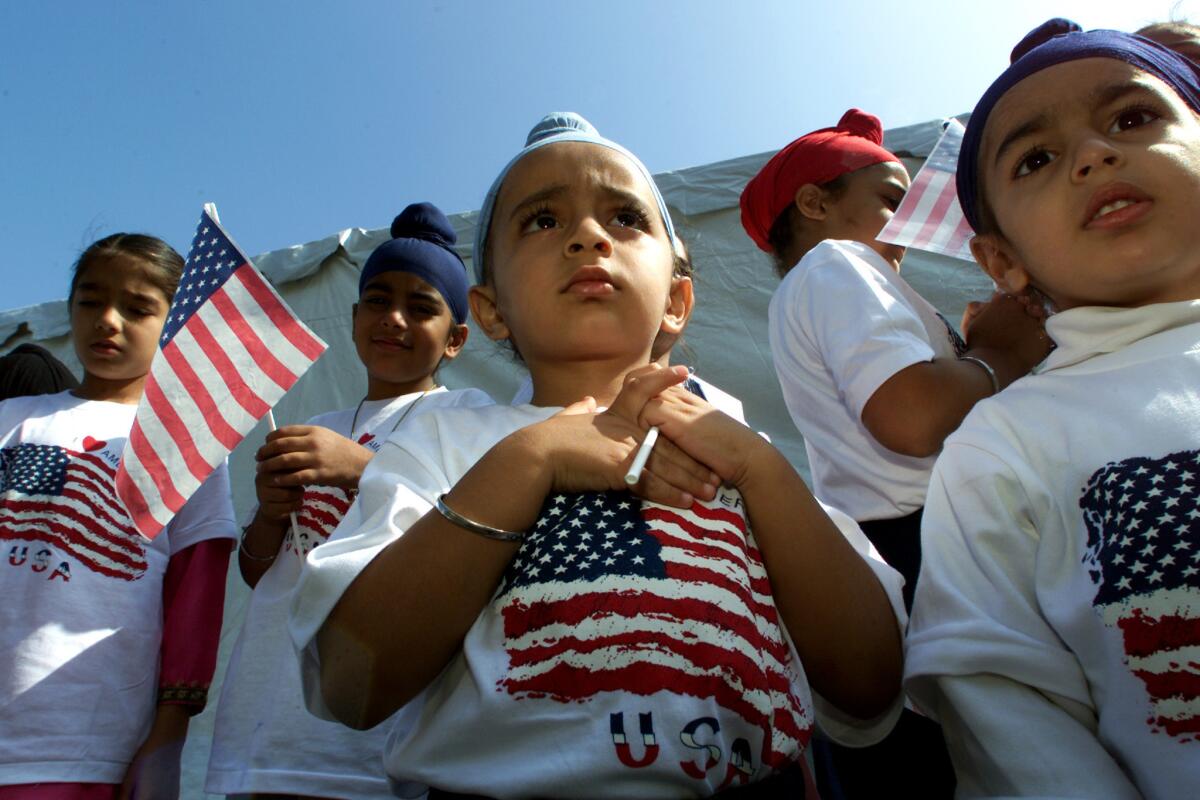 Harnadar Singh, 4, center, and other children prepare to say the Pledge of Allegiance on Oct. 10, 2001, at the Sikh Temple of Orange County in Santa Ana, at a ceremony to remember the victims of terrorist attacks.