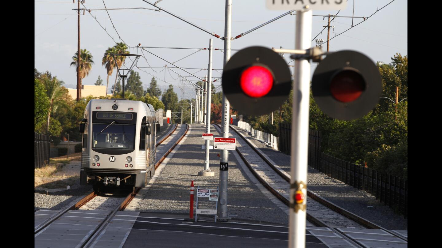 Metro workers perform a stress test on the new 11.5-mile Gold Line Foothill Extension, which will begin carrying passengers between Pasadena and Azusa in the spring.
