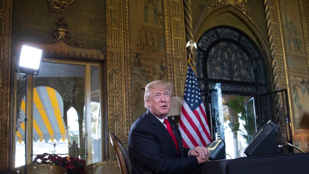 President Donald Trump talks to the media during a Christmas Eve video teleconference with members of the military at his Mar-a-Lago estate in Palm Beach, Fla., on Dec. 24.