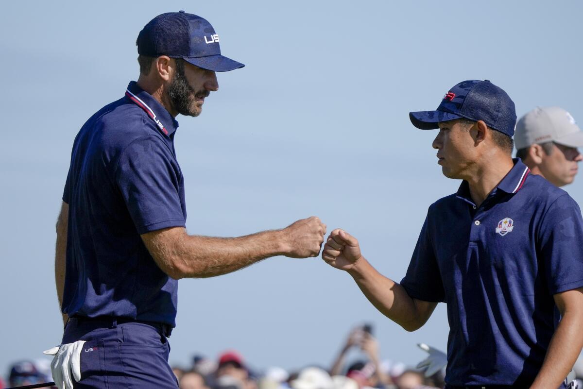 Team USA's Dustin Johnson, left, and Collin Morikawa celebrate on the 15th hole during a foursomes match Sept. 25, 2021.