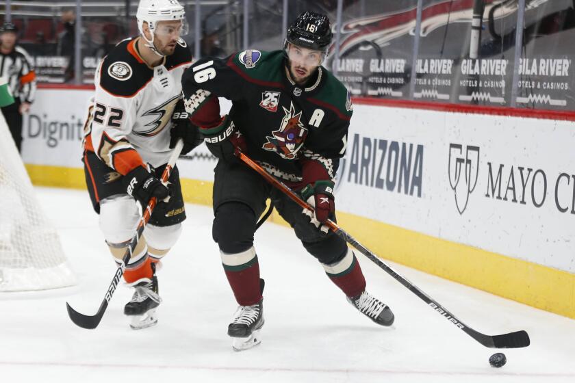 Arizona Coyotes' Derick Brassard (16) controls the puck against Anaheim Ducks' Kevin Shattenkirk (22) during the second period of an NHL hockey game Thursday, Jan. 28, 2021, in Glendale, Ariz. (AP Photo/Darryl Webb)