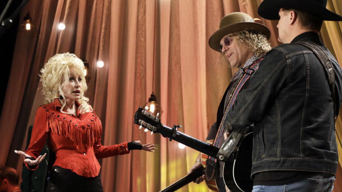 Dolly Parton talks with Kenny Alphin, center, and John Rich of Big & Rich during tapings for the "Smoky Mountains Rise Telethon" on Dec. 13.