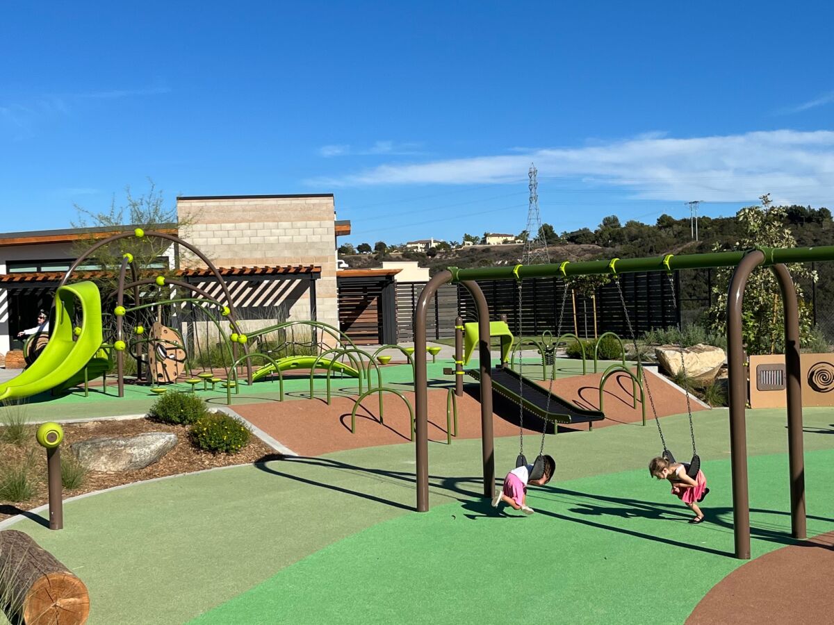 Kids test out the playground equipment.