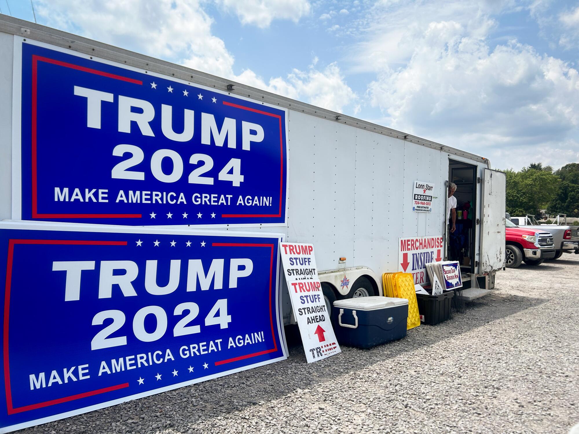 Two big "Trump 2024" signs are on a trailer.