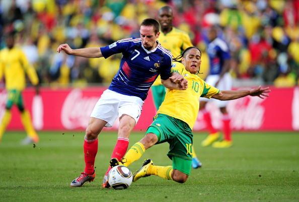 Steven Pienaar of South Africa tackles Franck Ribery of France during the 2010 FIFA World Cup South Africa Group A match between France and South Africa at the Free State Stadium on June 22, 2010 in Mangaung/Bloemfontein, South Africa.