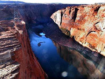 The Colorado River runs below Glen Canyon Dam in Arizona, slicing through rock walls on its way to the Grand Canyon.