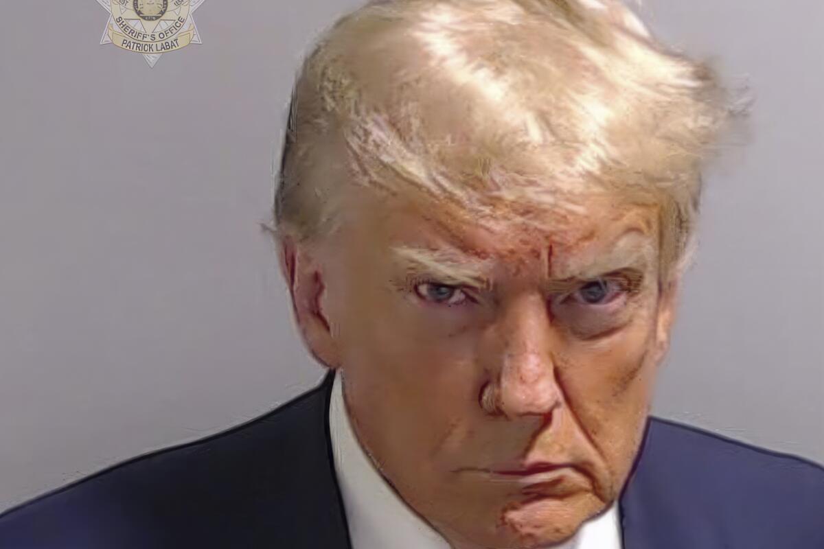 Former President Trump's booking photo if him scowling. 