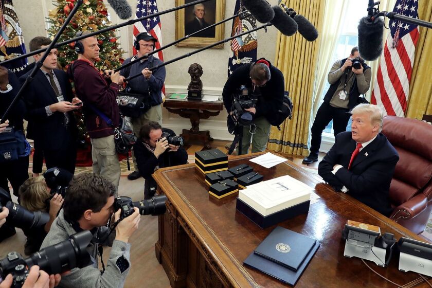 WASHINGTON, DC - DECEMBER 22: U.S. President Donald Trump talks with journalists after signing tax reform legislation in the Oval Office December 22, 2017 in Washington, DC. Trump praised Republican leaders in Congress for all their work on the biggest tax overhaul in decades. (Photo by Chip Somodevilla/Getty Images) ** OUTS - ELSENT, FPG, CM - OUTS * NM, PH, VA if sourced by CT, LA or MoD **
