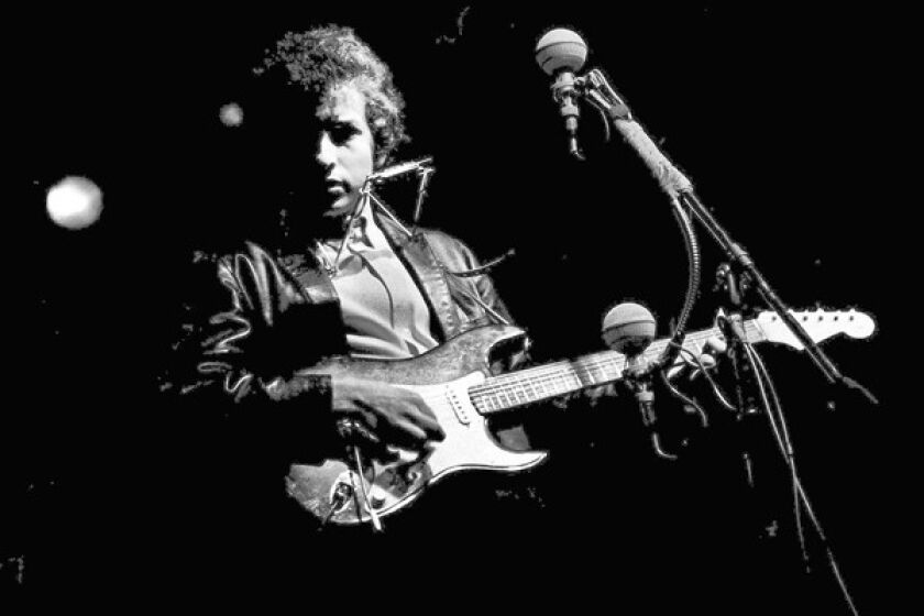 Bob Dylan goes electric at the Newport Folk Festival in 1965.
