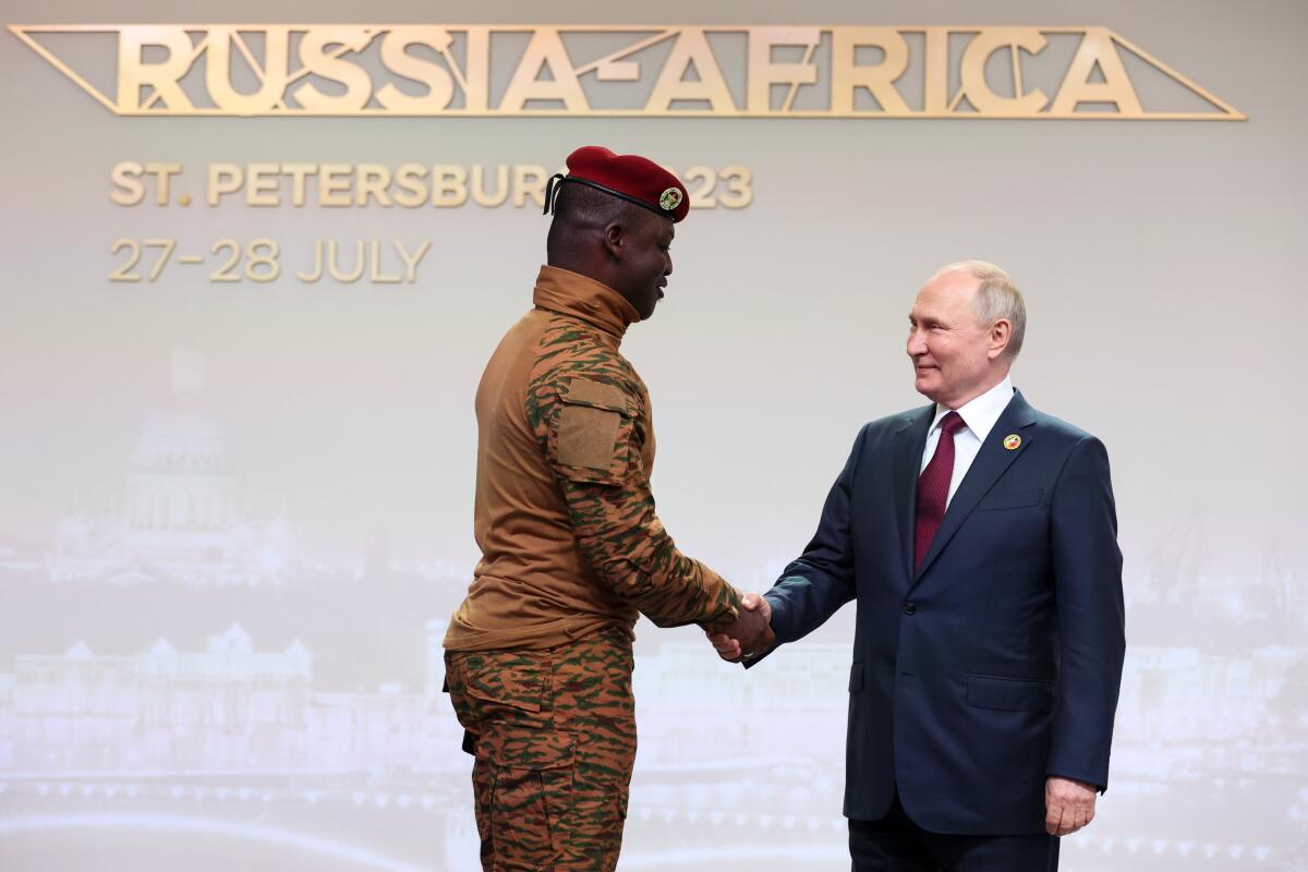 Burkina Faso's Capt. Ibrahim Traore, left, and Russian President Vladimir Putin shake hands.