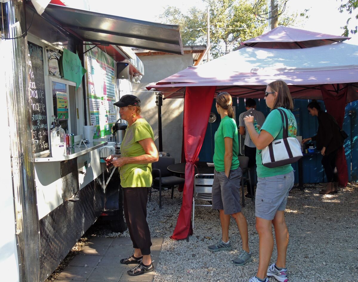Customers line up in front of Veracruz All Natural, a food truck in Austin, Texas.