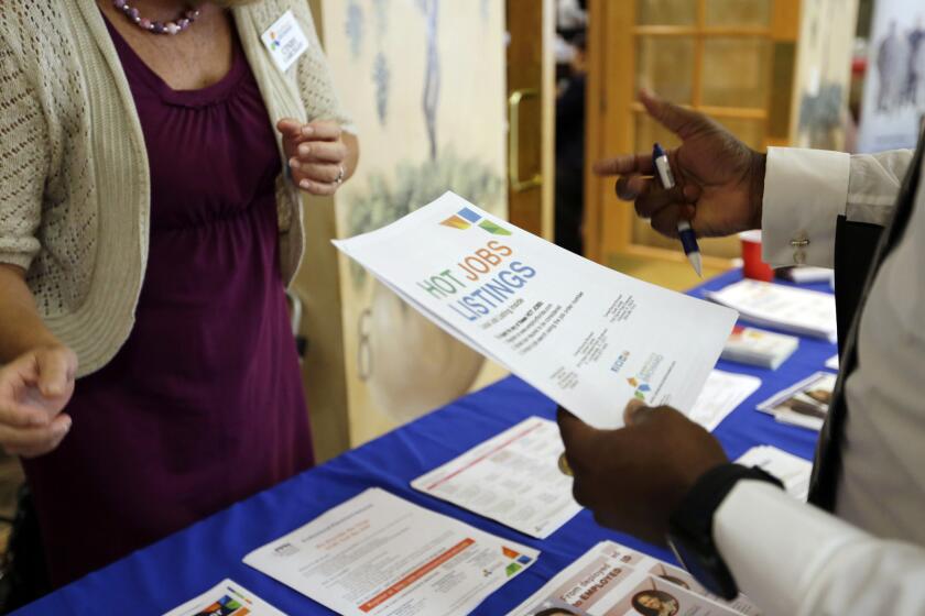 A job fair for veterans is held in October in Florida. Private-sector job growth accelerated to 217,000 in November, the ADP says.