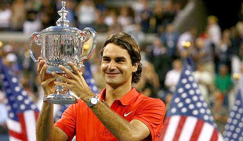 Roger Federer of Switzerland hoists the men's championship trophy after he defeated Andy Murray of Scotland in straight sets in the U.S. Open final on Monday night in New York.